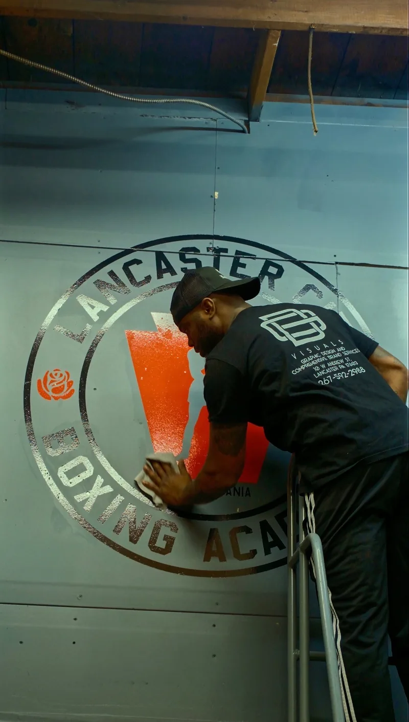 Installing the Lancaster City Boxing Academy wall logo