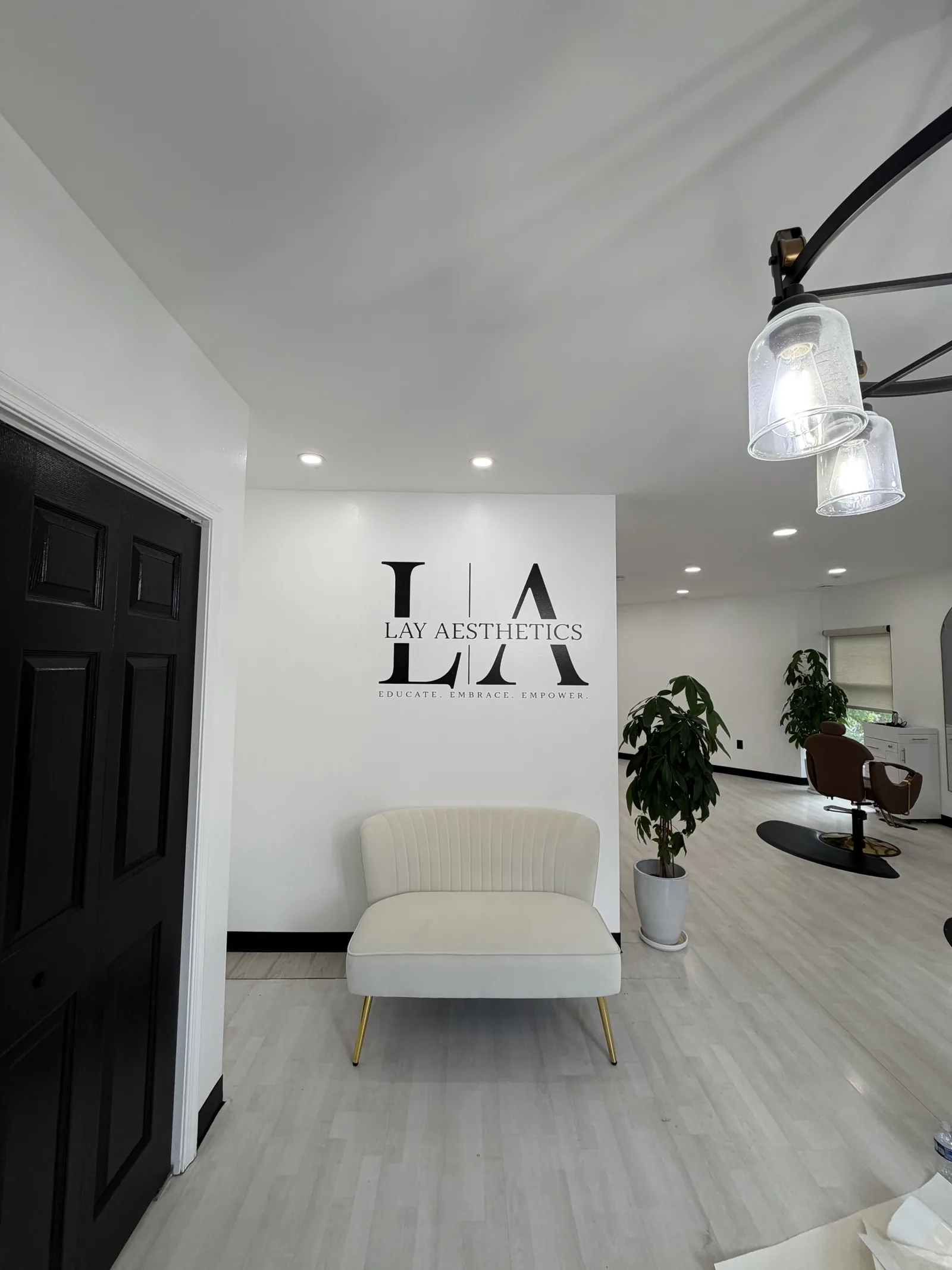 Lay Aesthetics wall logo in the salon